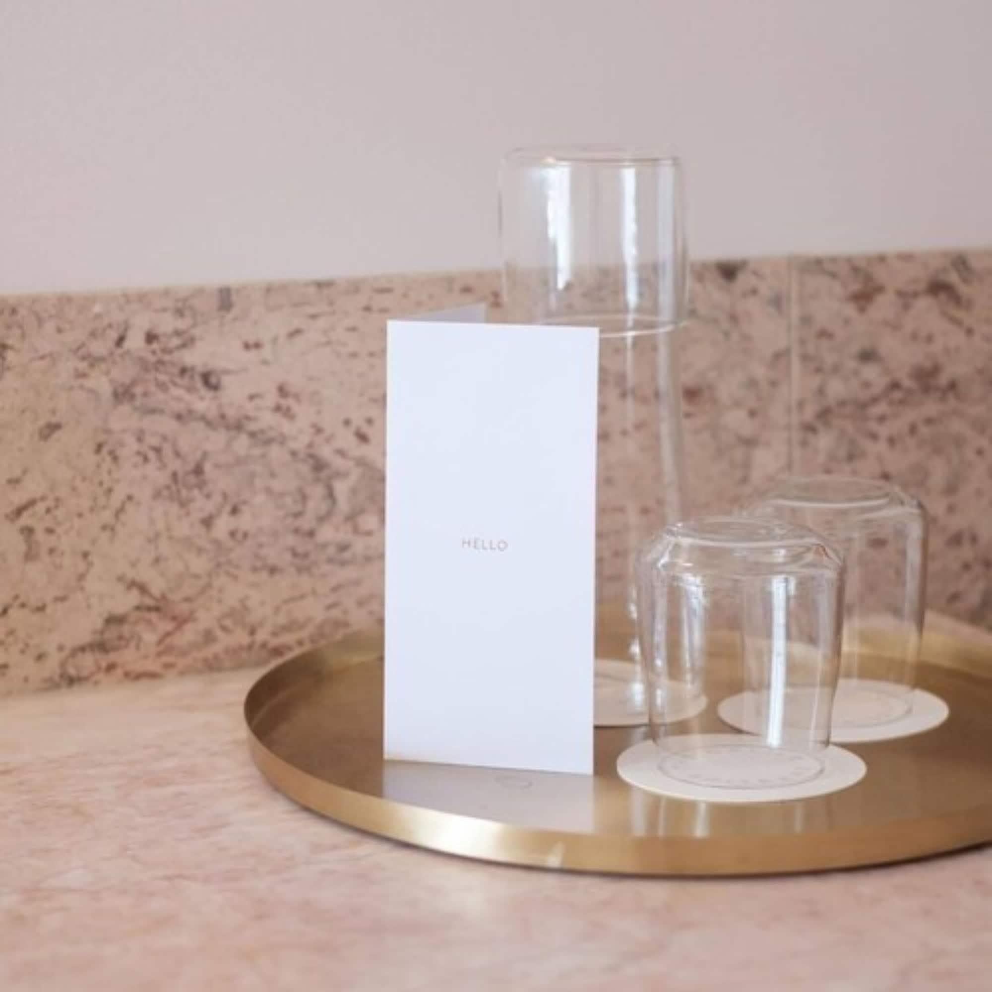 The Calile Hotel Брисбен Экстерьер фото A tray of water and glasses at a hotel